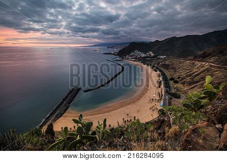 Coastline view of Playa de Las Teresitas beach, San Andres town and the capital city Santa Cruz de Tenerife in the background. The sand for this beach has been shipped from the Sahara desert