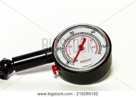 On a white background a close-up of a pressure gauge gauge for measuring tire pressure