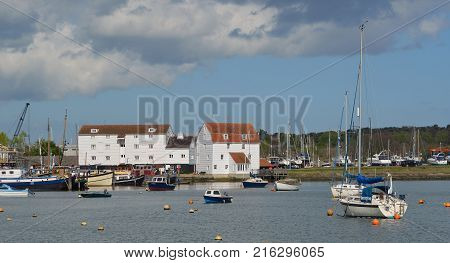 WOODBRIDGE, SUFFOLK, ENGLAND - APRIL 17, 2017: The River Deben at Woodbridge Quay with Tide Mill and Yachts.