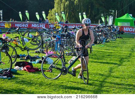 ST NEOTS, CAMBRIDGESHIRE, ENGLAND - SEPTEMBER 11, 2016: Triathlon competitor  just starting cycling stage of competition.
