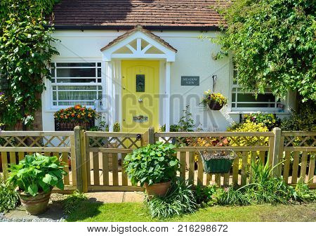 OFFORD DARCY, CAMBRIDGESHIRE, ENGLAND - MAY 22, 2017:  Cottage  with picket fence and Yellow door.
