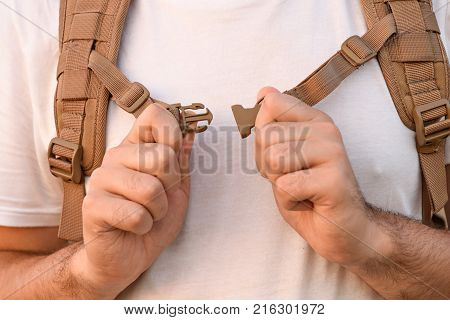 The Young Man Fastens Itself To The Fastex Buckle On The Chest From The Backpack
