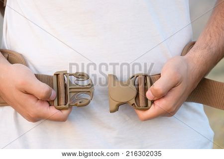 The Young Man Fastens Itself To The Fastex Buckle On The Chest From The Backpack