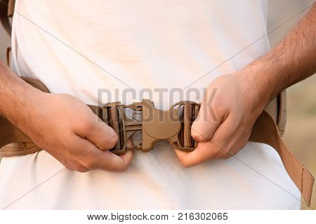 The Young Man Fastens Itself To The Fastex Buckle On The Chest From The Backpack