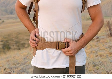The Young Man Fastens Itself To The Fastex Buckle On The Chest From The Backpack