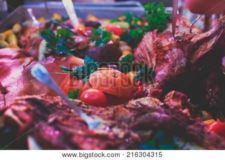 Big Giant Dish Plate With Roasted Full Pig Pork Head, Served In Restaurant With Variety Of Vegetable