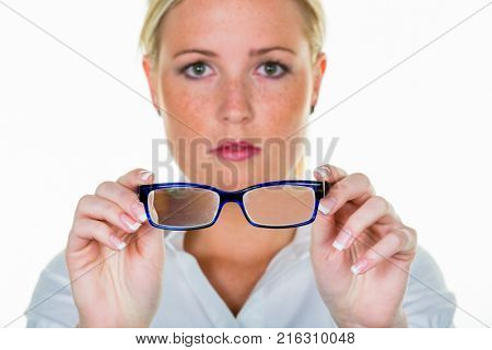 woman is holding a pair of glasses