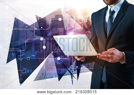 Businessman using laptop with circuit on abstract city background. Technology and communication concept. Double exposure