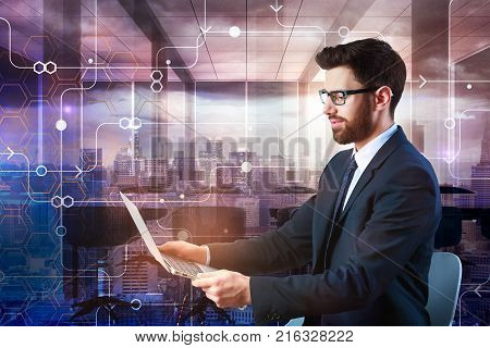 Businessman using laptop with circuit on abstract city background. Technology and network concept. Double exposure