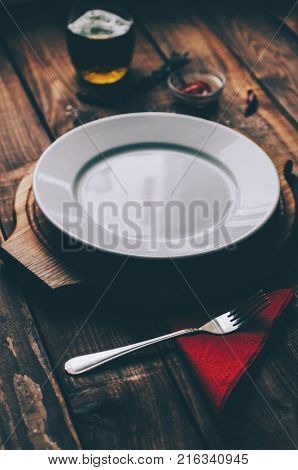 Empty plate on the home wooden rustic table