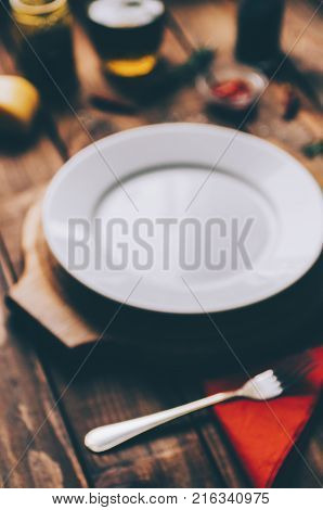 Empty plate on the home wooden rustic table, blurre defocused photo