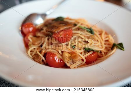 Plate with spaghetti melanzane in an italian restaurant