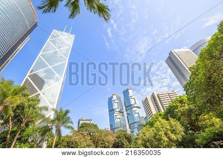 Hong Kong, China - December 7, 2016: Skyline of Bank of China and Lippo Centre in central business district in a sunny day seen from the Hong Kong Park, an oasis of peace in Hong Kong island.