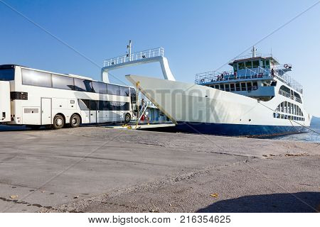 Large ferryboat has opened his front gate for boarding busses and other vehicles at the local port.