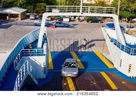Pefki Island Evia Greece - 11 July 2017: Anchored large ferryboat has opened his front entrance for boarding passengers at the local port.