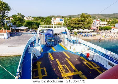 Pefki Island Evia Greece - 11 July 2017: Anchored large ferryboat has opened his front entrance for boarding trucks at the local port.