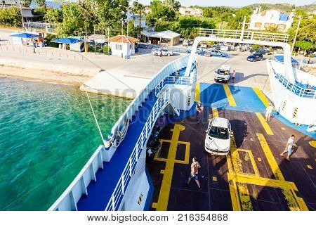 Pefki Island Evia Greece - 11 July 2017: Anchored large ferryboat has opened his front entrance for boarding passengers at the local port.
