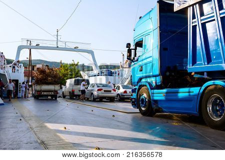 Pefki Island Evia Greece - 11 July 2017: Anchored large ferryboat has opened his front entrance for unloading people tourists and vehicles at the local harbor
