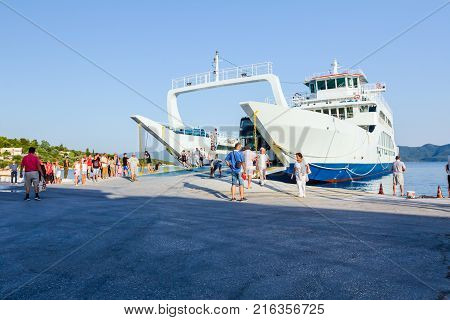 Pefki Island Evia Greece - 11 July 2017: Anchored large ferryboat has opened his front entrance for passengers to exit at the local port.