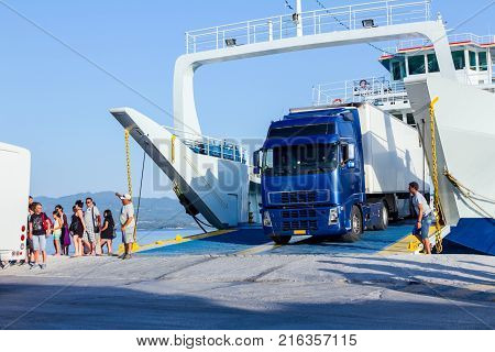 Pefki Island Evia Greece - 11 July 2017: Anchored large ferryboat has opened his front entrance for unloading vehicles at the local harbor