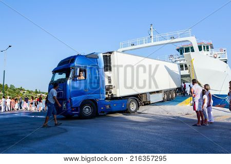 Pefki Island Evia Greece - 11 July 2017: Anchored large ferryboat has opened his front entrance for unloading vehicles at the local harbor