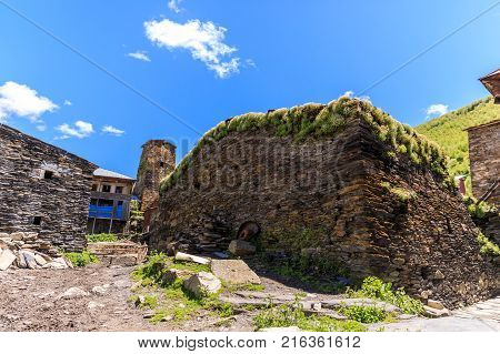 View of the Ushguli village at the foot of Mt. Shkhara. Picturesque and gorgeous scene. Rock tower towers and old houses in Ushguli