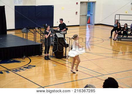 JOLIET, ILLINOIS / UNITED STATES - MARCH 23, 2016: A singer and a dancer collaborate in a performance at the Drauden Point Middle School's annual talent show.