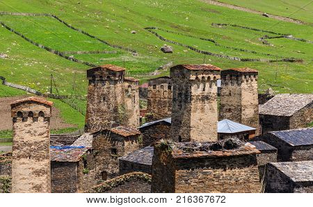 View of the Ushguli village at the foot of Mt. Shkhara. Picturesque and gorgeous scene. Rock tower in Ushguli - the highest inhabited village in Europe