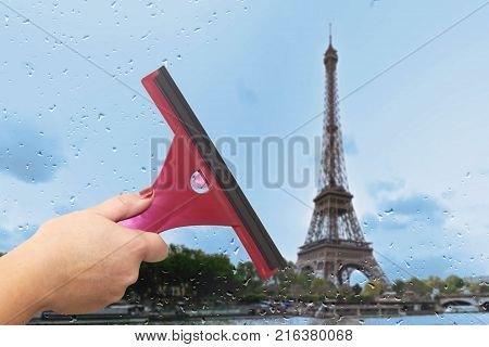 Worker washes the window after the rain. Paris. Tower