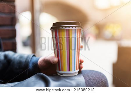 Close-up Of Female Hand Holding A Disposable Paper Coffee Cup