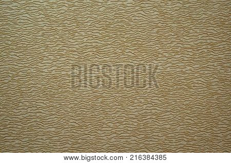 Paper dark beige with brown small spots relief in the form of waves embossing texture background.