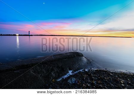 Nightfall overlooking Lac St Louis Lachine Quebec from the walking path with the sun behind the horizon.