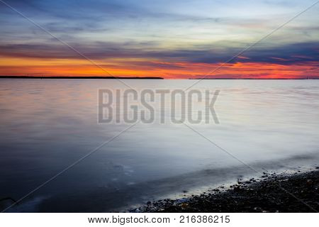 Nightfall overlooking Lac St Louis Lachine Quebec from the walking path with the sun behind the horizon.