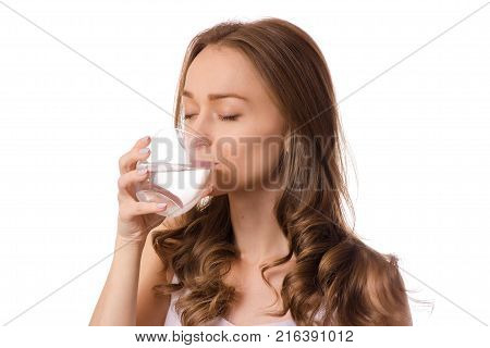 Beautiful young woman holding glass of water health on white background isolating