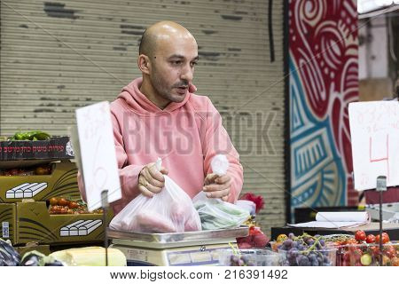 TEL AVIV , ISRAEL - 21 NOVEMBER 2017: Sellers on the old grocery street Nahalat-Benjamin