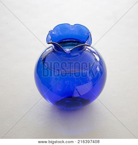 One beautiful cobalt blue vase on a bright white background.