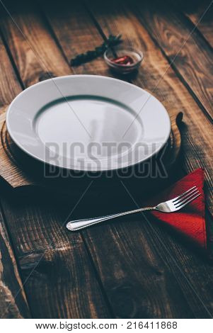 Empty plate on the home wooden rustic table