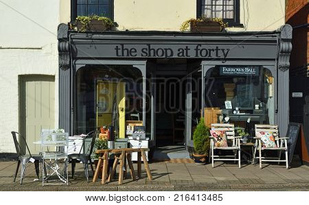 ST NEOTS, CAMBRIDGESHIRE, ENGLAND - SEPTEMBER 09, 2017: Store front of The Shop at Forty which sells Retro and Vintage wares with chairs and tables outside on the pavement.