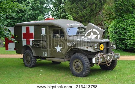 SILSOE, BEDFORDSHIRE, ENGLAND - MAY 28, 2017:  Second World War  Ambulance parked in front of trees.