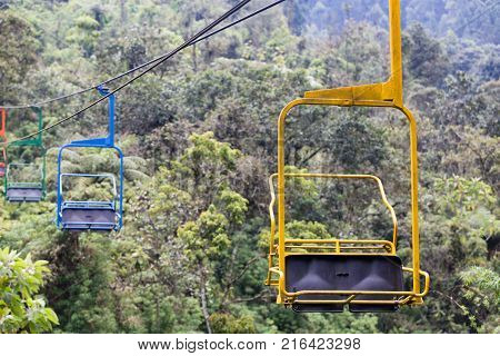 Yellow Blue Green And Orange Chairs On The Ski Lift At The Recinto Del Pensamiento Nature Reserve Ne