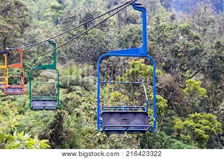 Blue Green Orange And Yellow Chairs On The Ski Lift At The Recinto Del Pensamiento Nature Reserve Ne