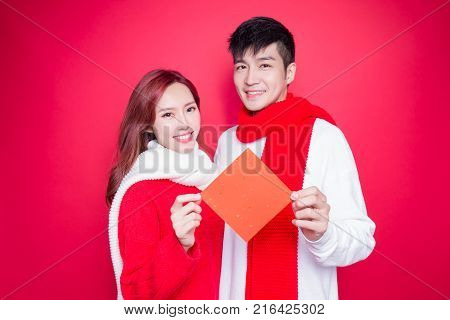 couple show couplets with chinese new year on red background