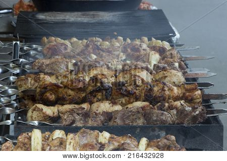 Marinated shashlik preparing on a barbecue grill over charcoal