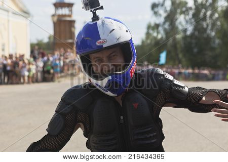 Verkhovazhye, Vologda region, Russia - August 10, 2013: Alexei Kalinin begins motorcycle show in the village Verkhovazhye and welcomes the audience by the hand driving in circles
