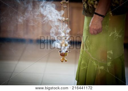 The woman holding the incense in the Orthodox Christian Church