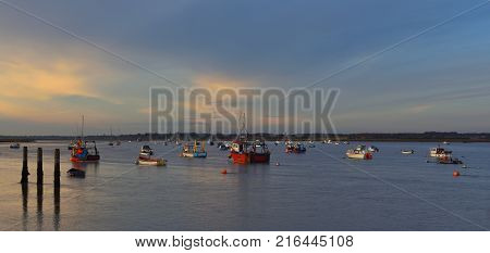 Boats moored in the River Deben at Felixstowe Ferry in the twilight.