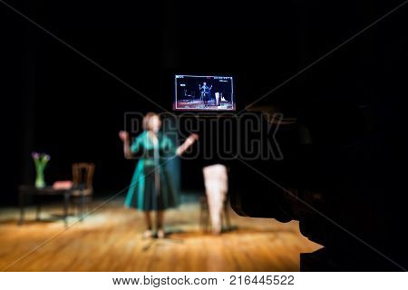 Filming performances of the actress or singer in the interior. A digital video camera. Color led display. The TV Studio.