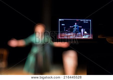 Filming performances of the actress or singer in the interior. A digital video camera. Color led display. The TV Studio.