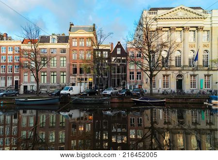 Facades of historic dutch houses over canal with mirror reflections, Amstardam, Netherlands, retro toned