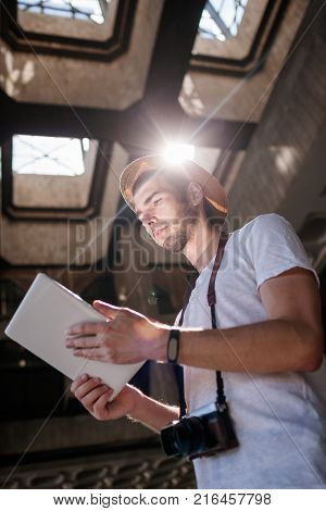advanced modern photography practices. tablet and photo camera connection to see photos in high resolution. contemporary technology concept